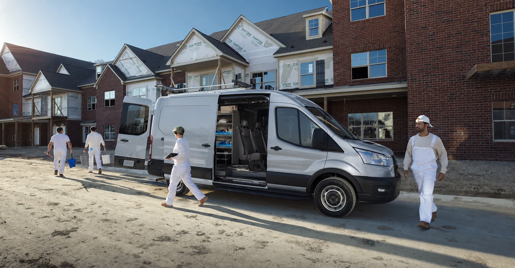 Professional painting crew arriving at a residential project with equipment